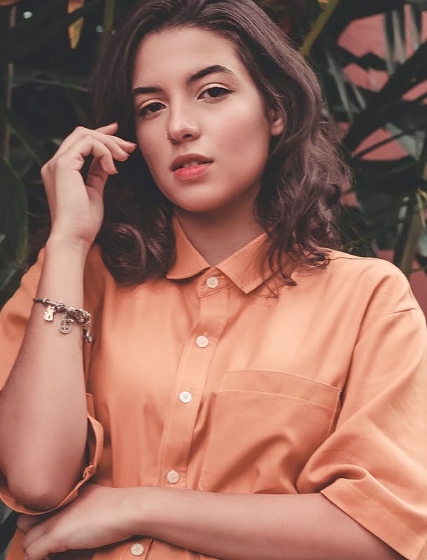 A female model with a light orange t-shirt